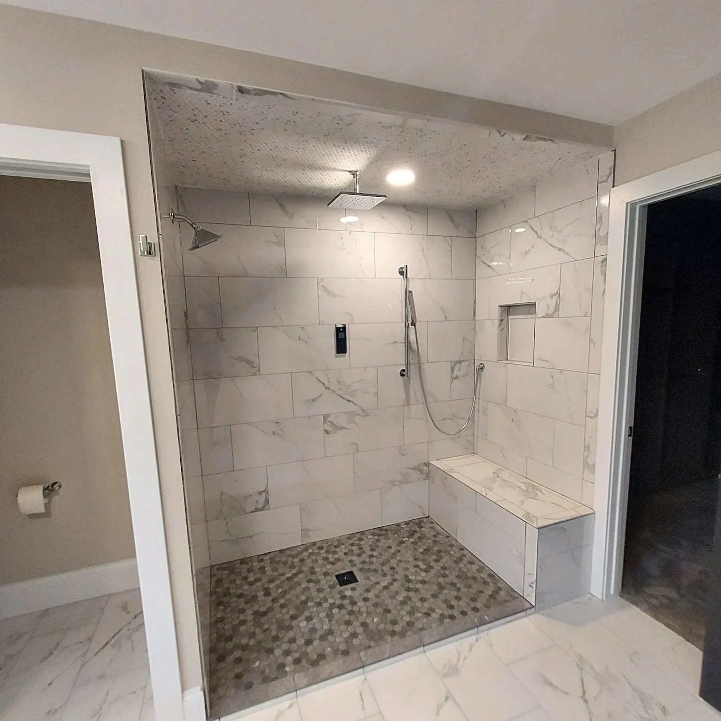 A bathroom with a shower and bench in it