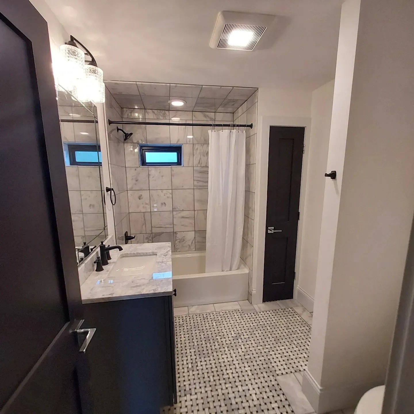 A bathroom with a sink, toilet and shower.