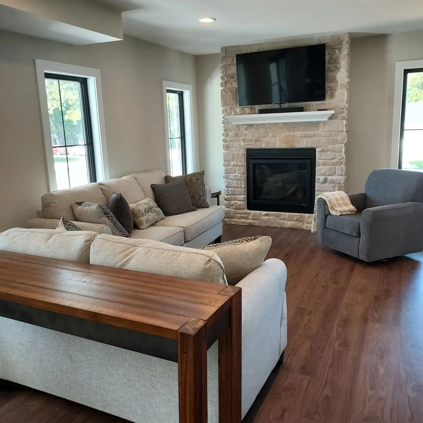 A living room with couches and a television.