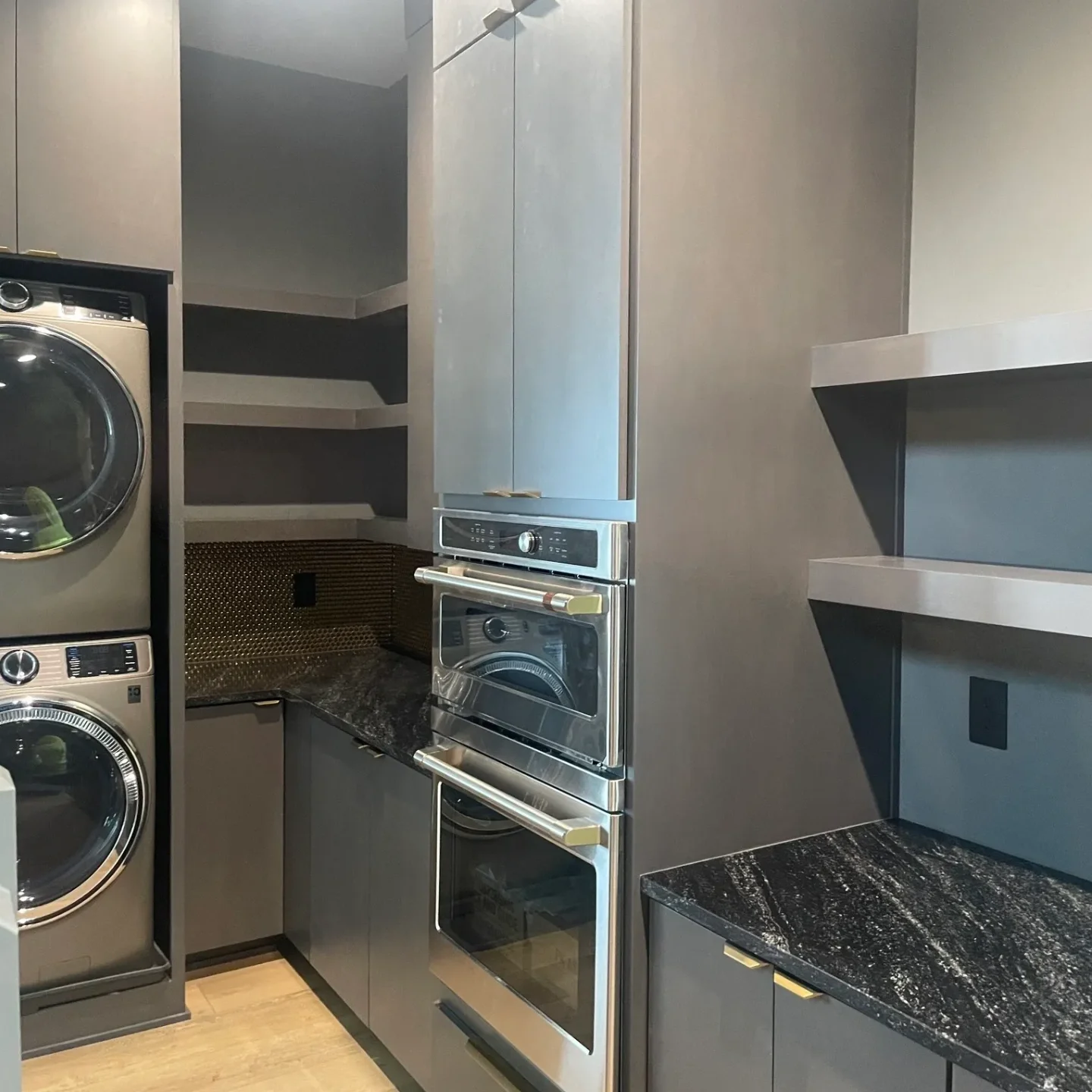 A kitchen with a washer and dryer in it