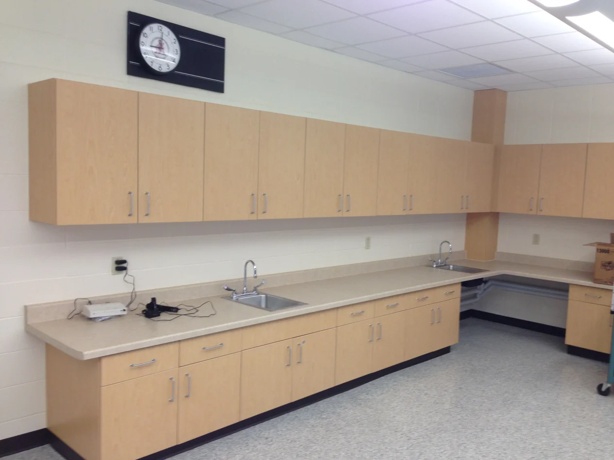 A large room with many cabinets and a clock.