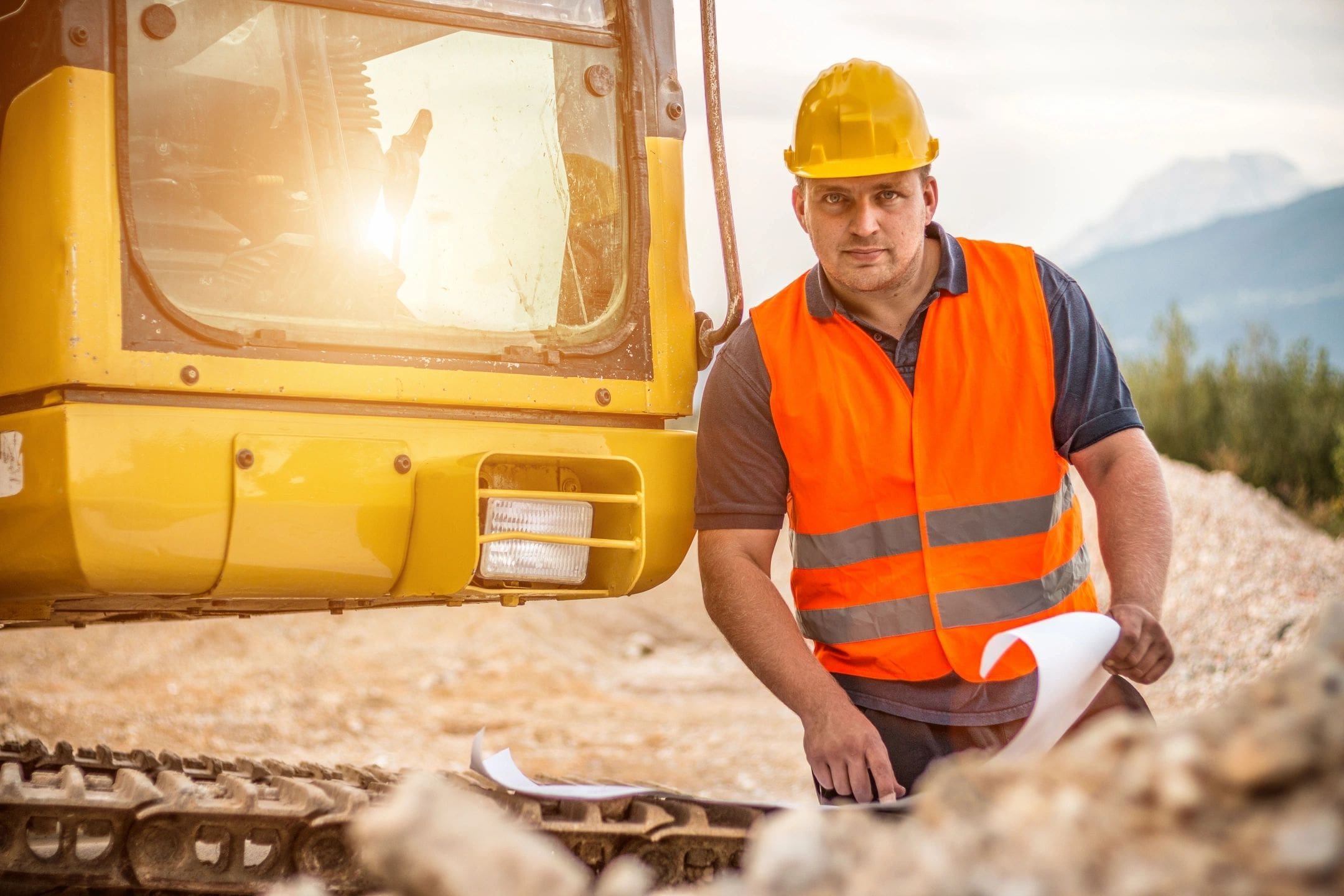 A man in an orange vest and hard hat.